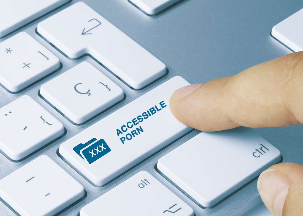 A finger touches a key on a computer keyboard that has the text "Accessible Porn" there is an icon of a file folder with three Xs